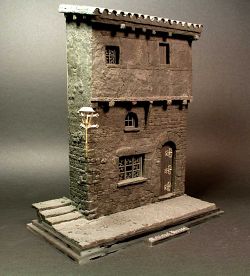 Medieval house corner with steps and street
